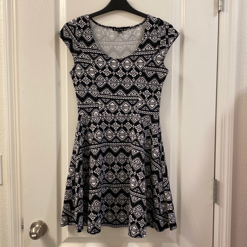 Black and white short dress with geometric patterns.